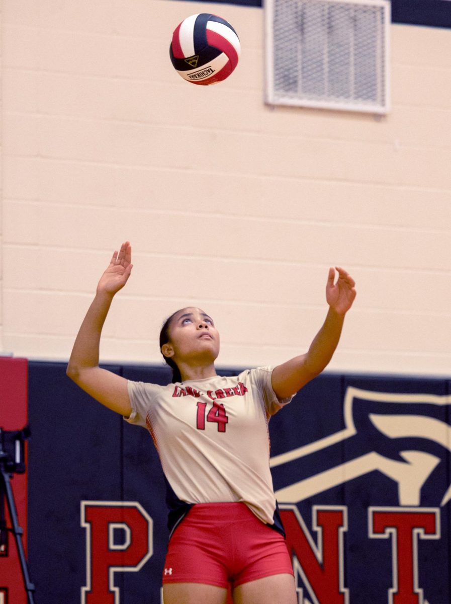 READY FOR THIS?
Senior Marissa Solorzano prepares to do a float serve as she tosses the ball into the air. “When I first started playing, I could barely get the ball close to the net,” Solorzano said. “Over the years I started incorporating different techniques like the float serve and top spins.”