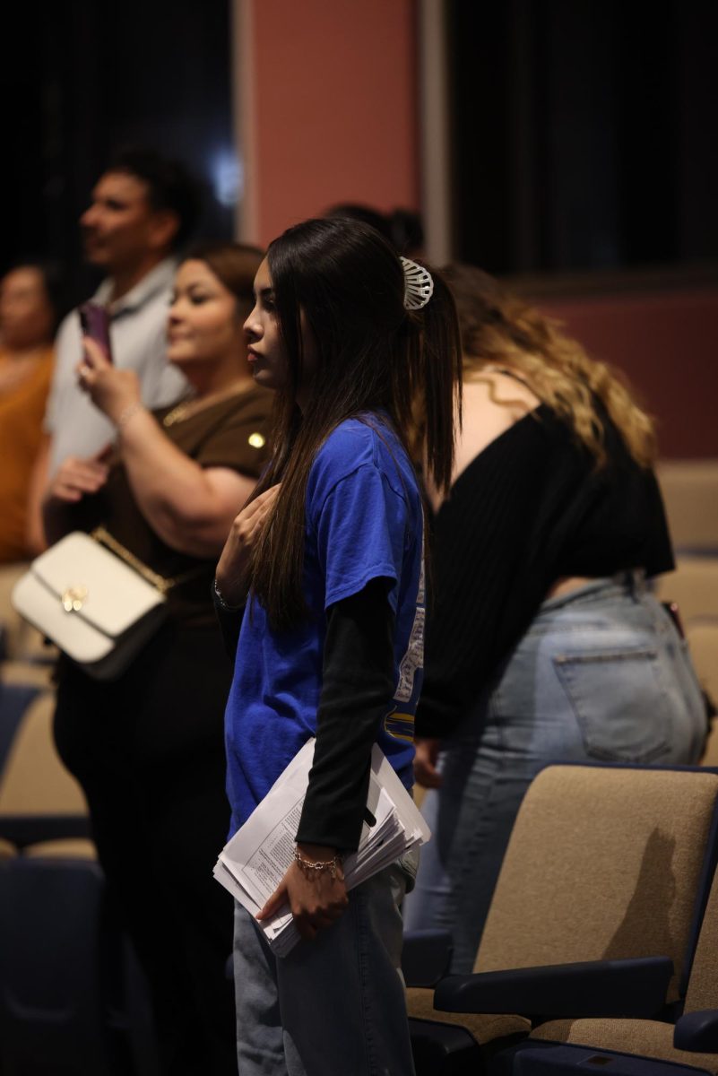PROUD. Senior Donna Garcia stands looking toward the flag for the pledge of allegiance at the NEHS induction ceremony Sept. 9, 2025. NEHS officers led the pledge of allegiance before the induction began. “I felt happy and proud of the new inductees because it is a good opportunity for school and social life,” Garcia said.