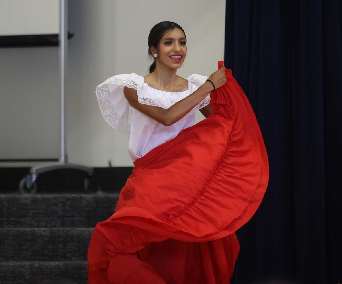 QUICK STEP. Junior Vanessa Rodarte picks up her skirt and swings, creating a wave-like motion as she keeps a wide smile on her face at Creighton Elementary on Oct. 9, 2025.