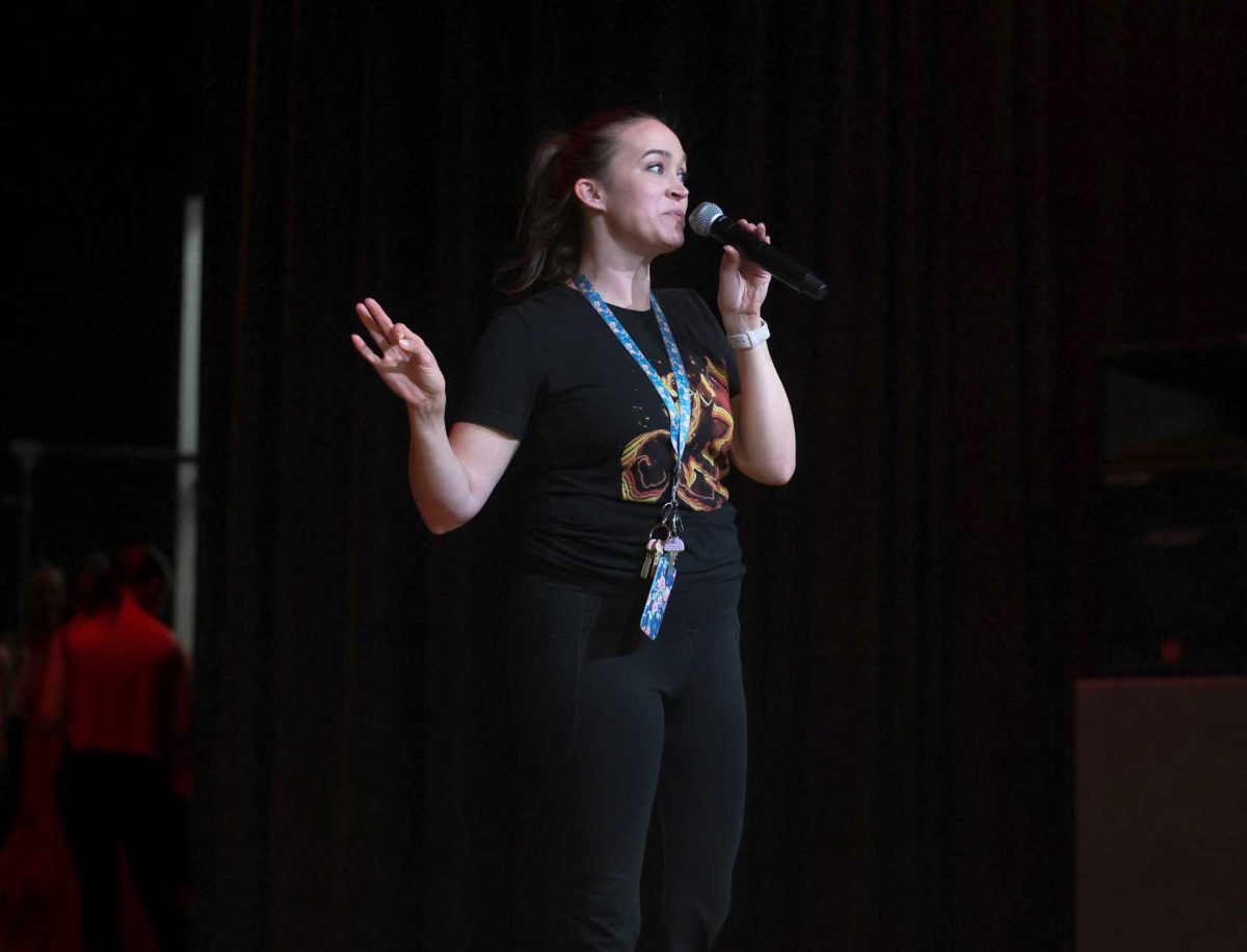 BUILD UP. Before the Starlettes officers perform on Tuesday, Oct. 14, dance coach Ms. Kloes hypes up the audience of elementary school students at Creighton Elementary by talking to them about the performances.