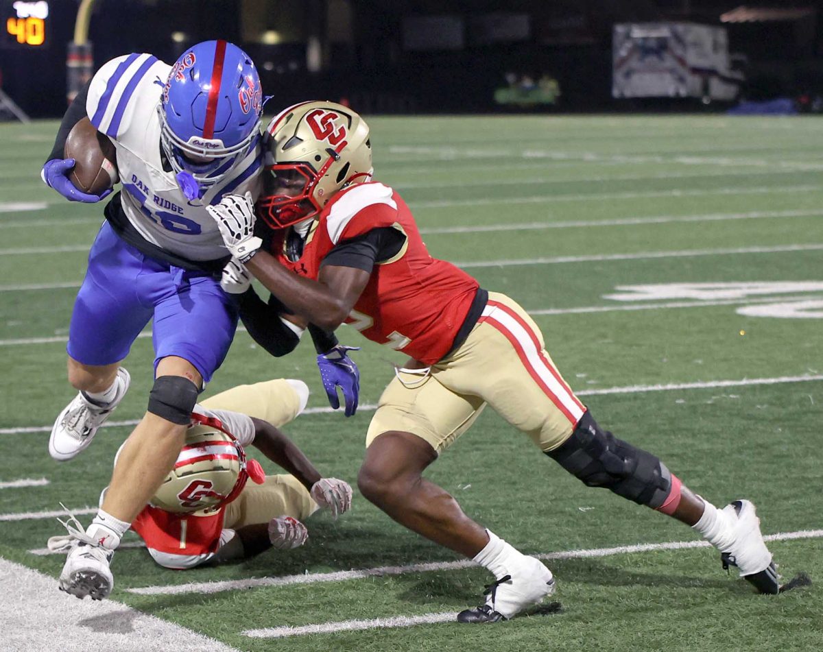 UNSTOPPABLE. Senior Marcez Jackson tackles the offense during the Halloween football game against Oak Ridge. Jackson pulled off many more tackles, making the War Eagles halt in their push.