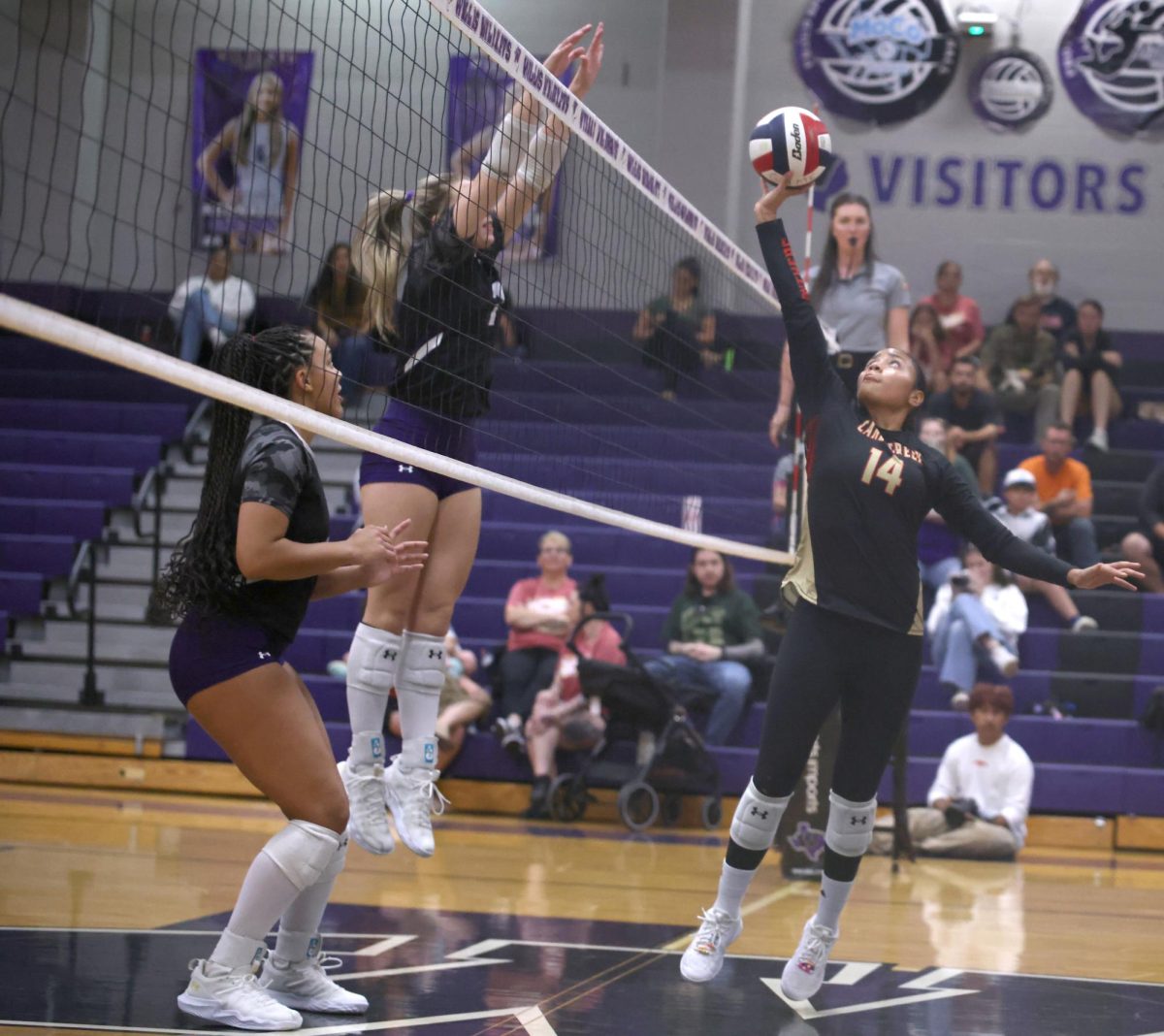 OVER THE NET. During the game against Willis on Sep. 26, 2025 senior Marissa Solorzano tipped the ball over and almost gave her team a point. “I was telling my teammates if I saw them get in their heads I was like forget about it, this is a game of mistakes,” Solorazano said. 