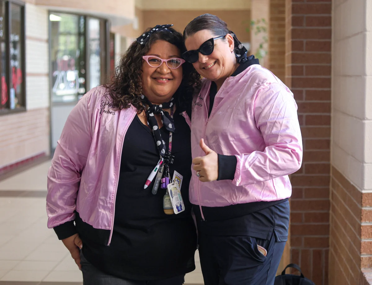 LADIES IN PINK. Science teacher, Kathy Perla and Cheer coach, Janel Jackson dressed as Ladies in pink on Oct.1, 2025. Students and staff members were able to dress up from any time period representing the different decades for the homecoming spirit week. The Pink Ladies was a group created in the 1950’s. 