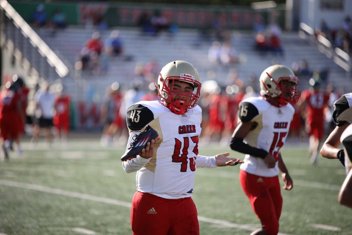 Freshman David Huerta holds up his shoe and shrugs on Sept. 24, 2025. Huerta was going against two defenders and got pushed over, and they made his shoe fall off.