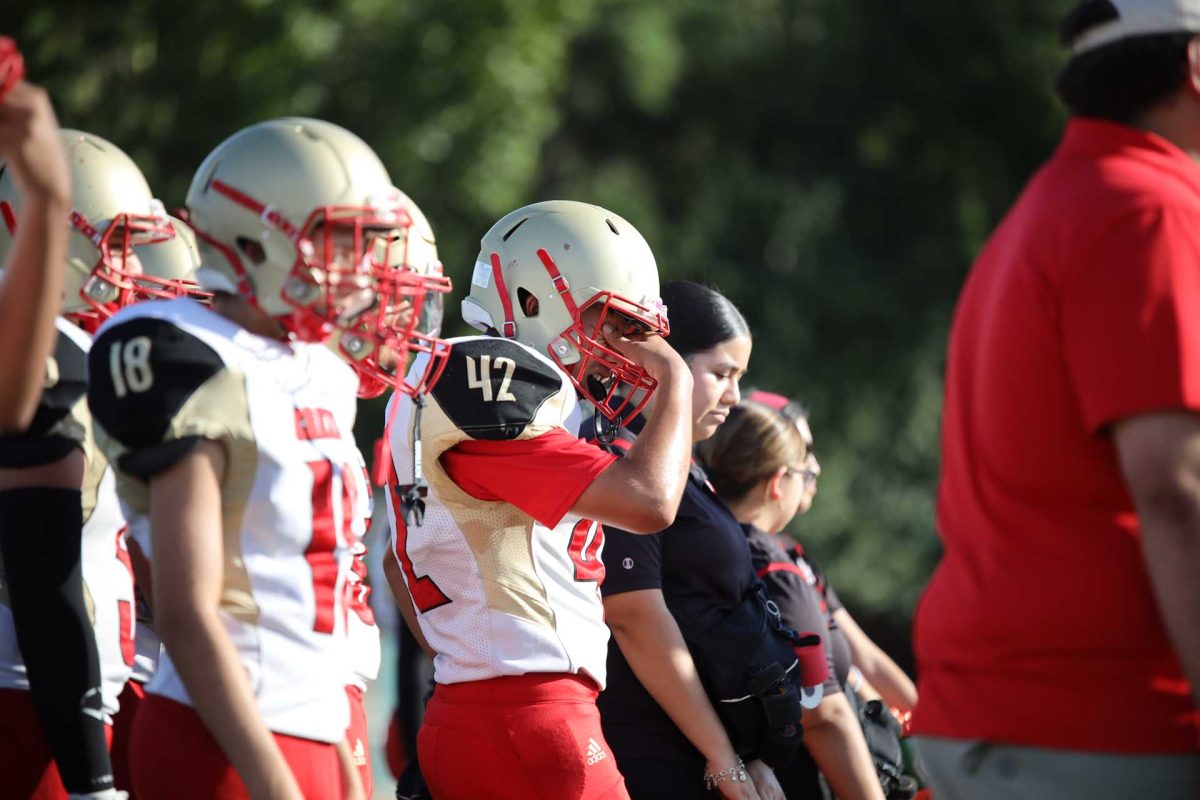 Freshman Abraham Guzman was wiping his face to get sweat out of his eyes on Sept. 24, 2025. Guzman was working hard before and during the game causing him to sweat a lot. 