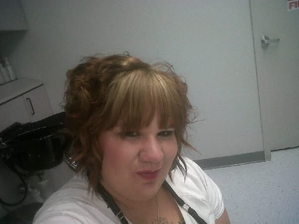 Mary Loveless-Day takes a self-portrait photo after styling her hair. Photos was collected from Mary's archived Facebook posts.