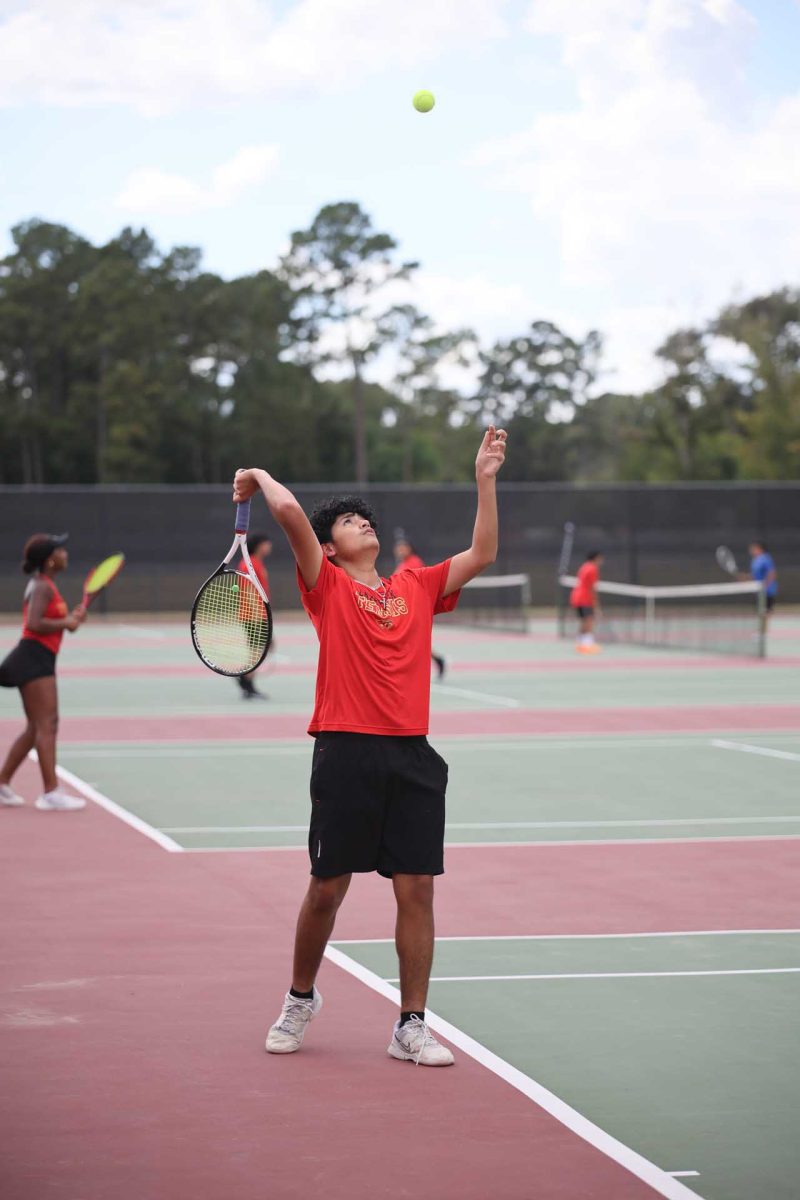 LOVE. Junior Adrian Gonzalez was getting ready to serve, confident about it, he threw the ball up watching it like a hawk, waiting for the right moment to strike and score his duo and him a point in the Oak Ridge game on Thursday, Sept. 23, 2025.