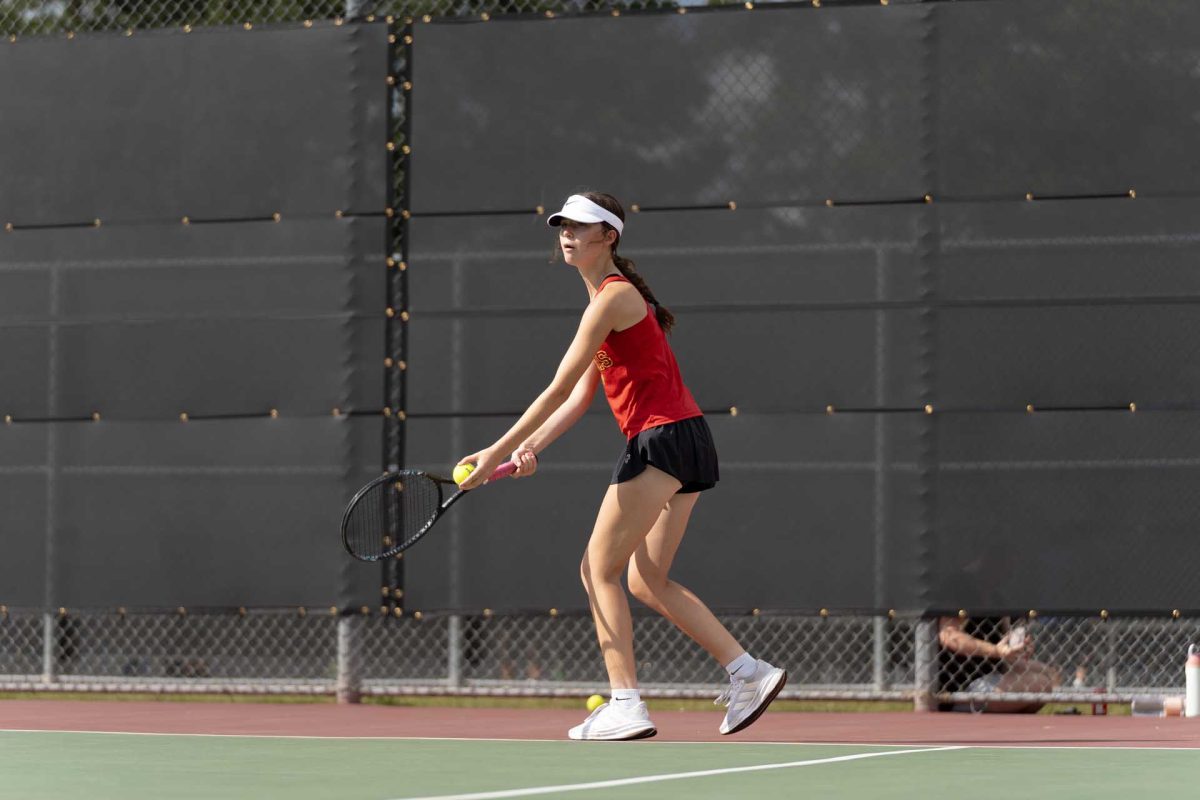 SERVING WHILE SERVING. Sophomore Madison Vitale gets ready to serve with the ball in hand building up momentum during the match against Oak Ridge on Thursday, Sept. 23, 2025. Vitale has continued to refine her technique this season as she works to become a more consistent player. 