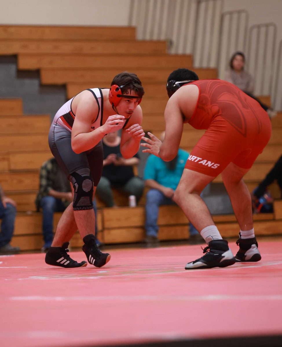 WILD PRAY. Sophomore Xander Heimbuck in his stance ready to pounce on his opponent during a home match Vs Cypress Lakes on Jan 8, 2026. Heimbuck looks for an opportunity no matter how tired he is. “I always try to stay positive, making sure I'm in the right head space," Heimbuck said.