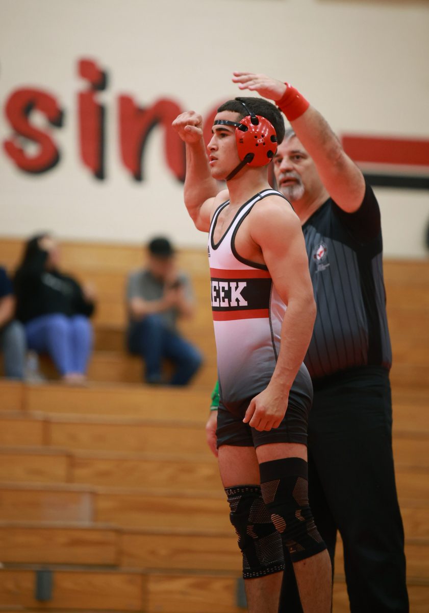 VICTORY. Senior Luis Bonilla raises his arm after winning a match on Jan 8, 2026 against Cypress Lakes. Bonilla was able to finish a quick match while being agile with his movements. “It's all about dedication and hard work,” Bonilla said.