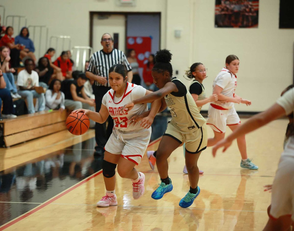 LANE ATTACK. Freshman Leah Cortez battles on the sideline against a Conroe High School player on Jan. 09, 2026. “I was nervous when it hit overtime,” Cortez said. “ It was my first time , I was tired but pushed with everything to get the point.”