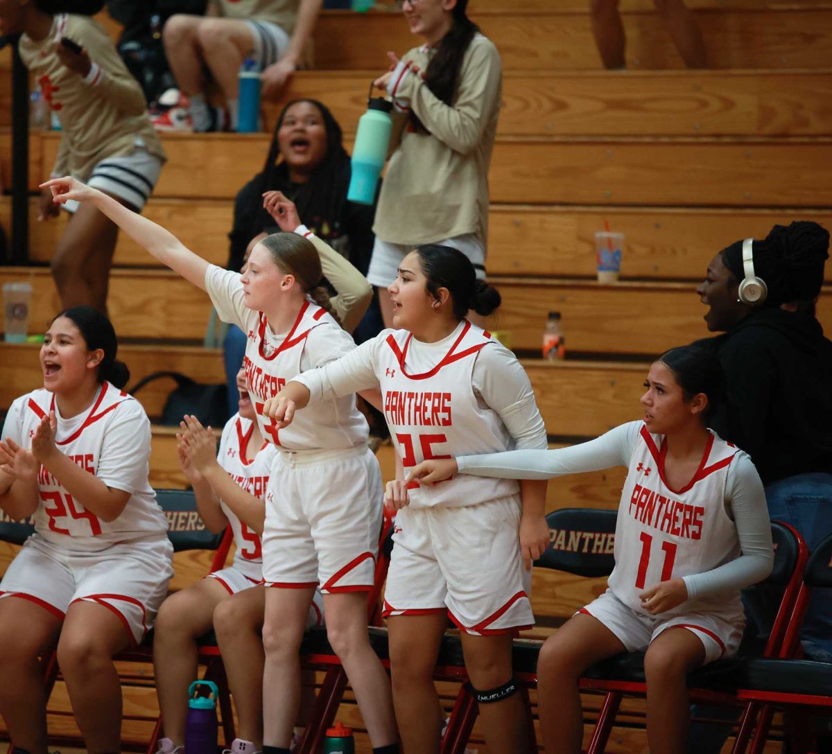 SPIRIT SURGE. Freshman Royie Yoakley and Daliyah Tamayo on the sideline encouraging their teammates to shoot during a breakaway against Conroe on Jan. 09, 2026. “Motivating my team is the most important thing especially in games like this,” Yoakley said.