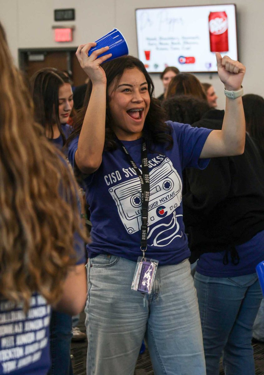 DR. PEPPER. Senior Britney Zapata celebrates after winning the Dr.Pepper game against another student council member during the mid-level conference on Monday, Feb. 9, 2026. The Dr. Pepper game consisted of players touching the body part that was instructed by the game leader and when the leader yells cup, the player is supposed to grab the cup as fast as possible to beat their opponent. 