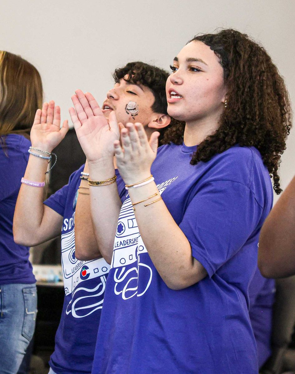 DECADES PARTY. Junior Josias Godinez and sophomore Laurie-Anne Garcia sing along to the decade's party song and show their spirit during the mid-level conference that was held on Monday, Feb. 9, 2026. High schools and middle schools all united to conduct several activities as “Ice Breakers” for the middle school students to loosen up and show all the spirit they could. 