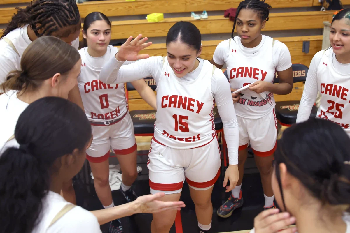 SETTING THE TONE. Senior Yeiry Zamudio dabs up the entire varsity team before their game begins against Conroe High School on Jan. 09, 2026. Zamudio always gets the team hyped up before the game, and talks to them about what they need to bring for certain games to make sure they get the win. “To lead by example through hard work, accountability, and positive communication, and I make sure my teammates feel supported and motivated, whether we’re winning or losing,” Zamudio said. 