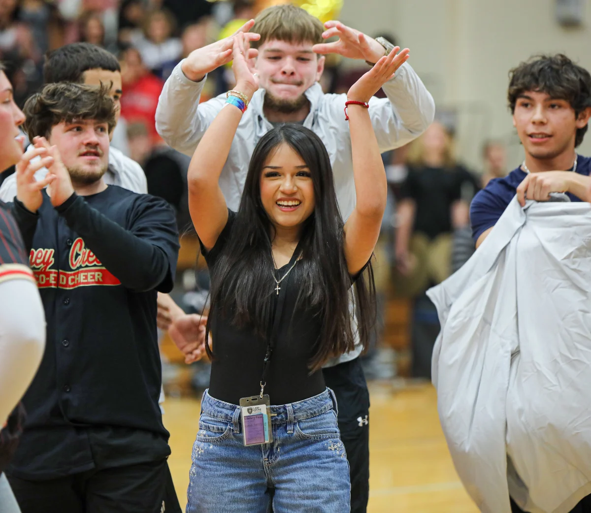 WINNER. Freshman Alondra Rodriguez raises her hands as the speaker announces her as the winner during the winter sports pep rally on Thursday. Feb. 5, 2026. One person from each of the sports teams competed against each other by doing as many push ups they each could do. 