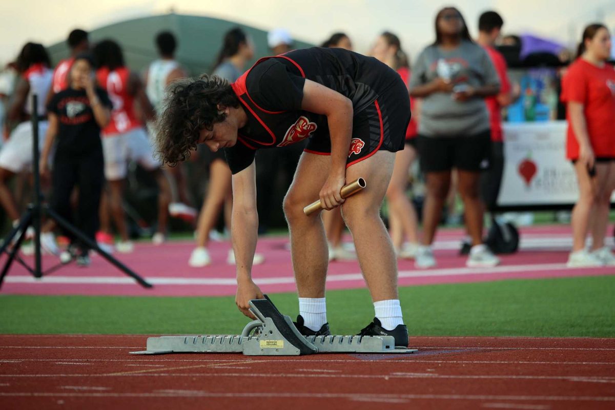 SETTING UP. Sophomore Corbin Hornsby was sets up his block to start his relay on Thursday March 6, 2026. “If I get nervous before a race I pray before it and hope everything comes out good,” Hornsby said. 