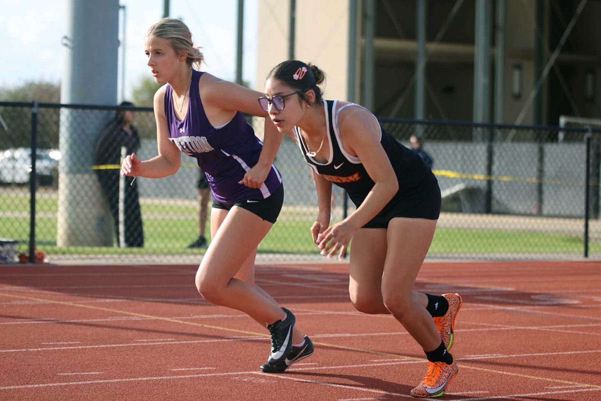 LOCKED IN. Senior Stacy Balderas positions herself at the starting line about to start her mile on Thursday March 6, 2026. Throughout the race Balderas kept a good pace and put Caney Creek at a good spot. “Before my race I usually say a prayer on the track,” Balderas said. 