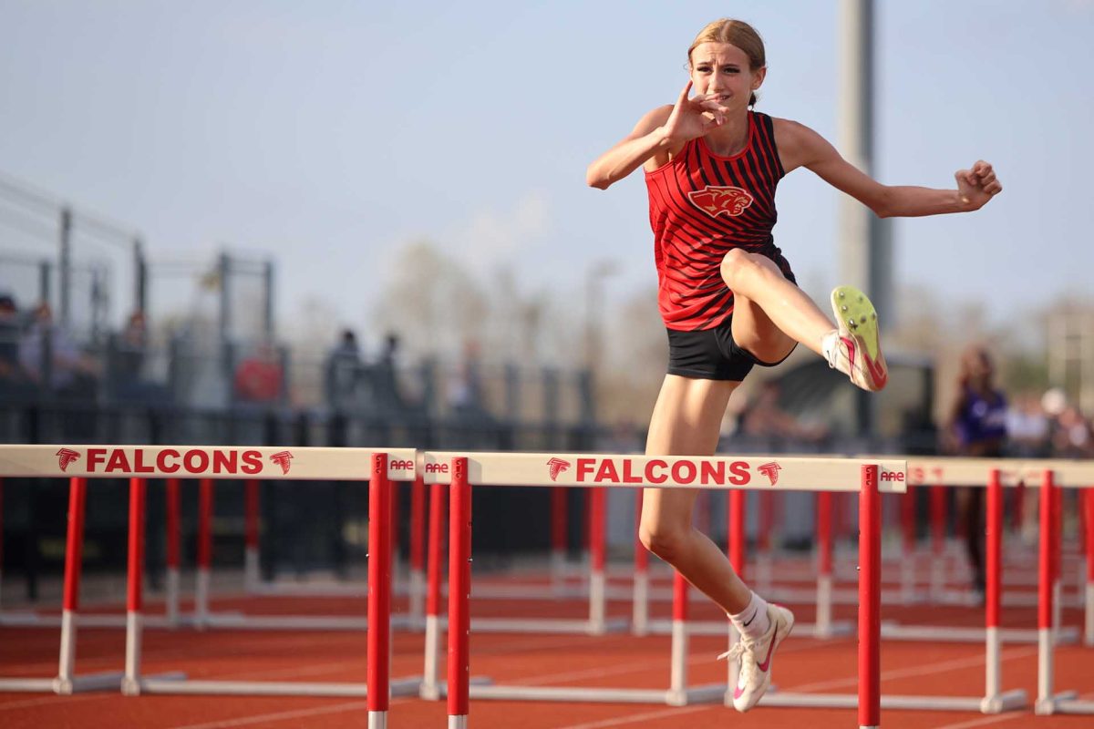 CATCH UP. Junior Randi McCord was in second place while running the 100 meter hurdles on Thursday March 6, 2026. McCord was close to reaching the first place runner but came up short and ended in second place. 