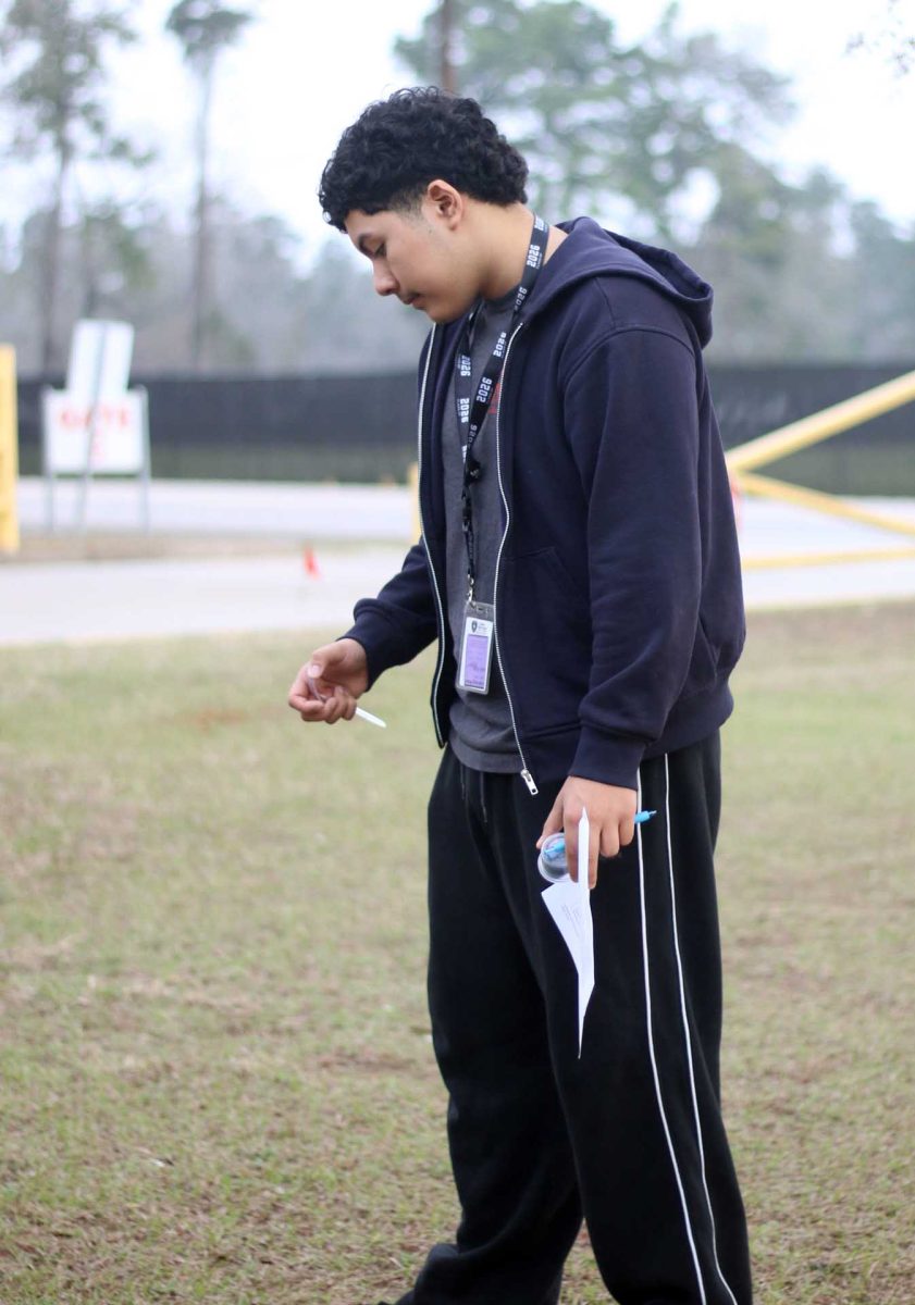 OBSERVE. Senior Jesus Acosta Almanza looks down at his fork where his bean fell on Thursday, Feb. 19, while waiting for his classmates to finish documenting their experiment. Students all documented their recordings on a paper. 