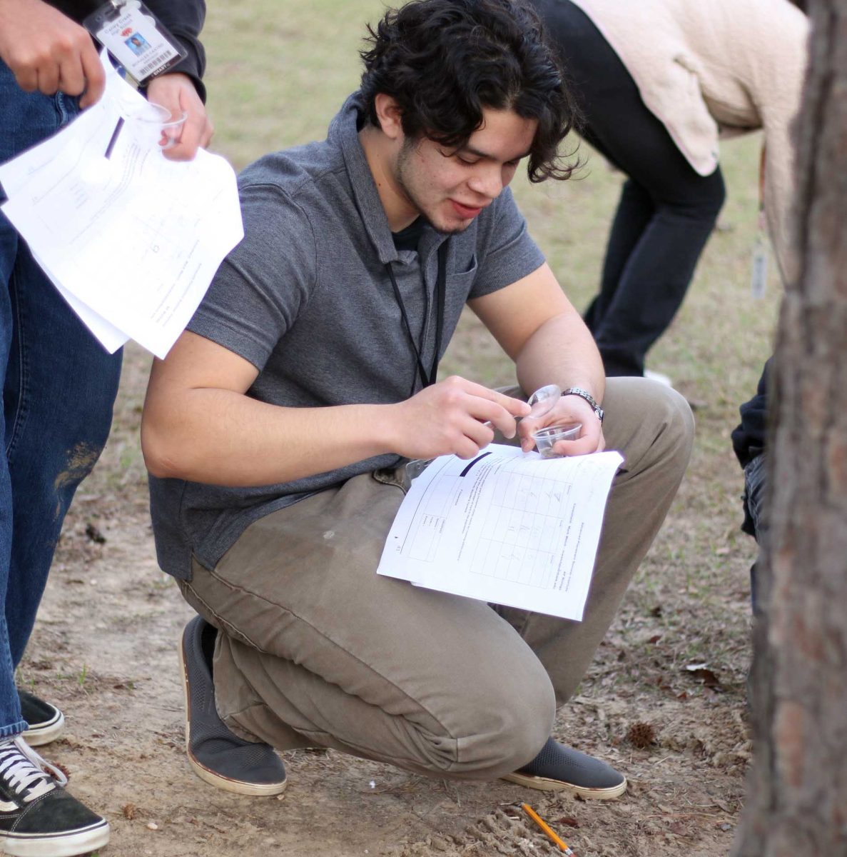 BEAN CATCHER. Senior Jason Montes placed the bean he collected into his cup on Thursday. Feb. 19, before completing his documentation on his collected data. Students were asked to conduct experiments picking up beans for their AP Biology class. 