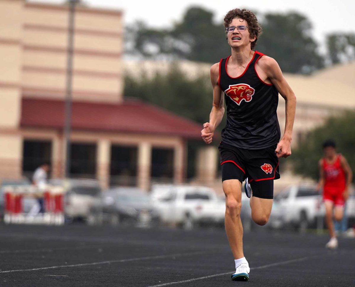 ALL IN ONE. Sophomore Hunter Gray pushes himself on his final lap to finish his two mile run at the Panther Relay Meet on Thursday Feb, 26. Gray gave his all and placed top 5 in the two mile. 