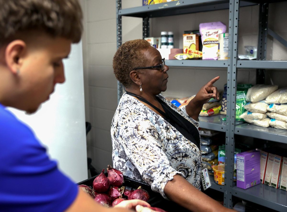 NEVER HUNGRY. Communities in Schools site coordinator Regina Burks walks through the CIS pantry while preparing food for students April 22. CIS offers snacks to students in need.