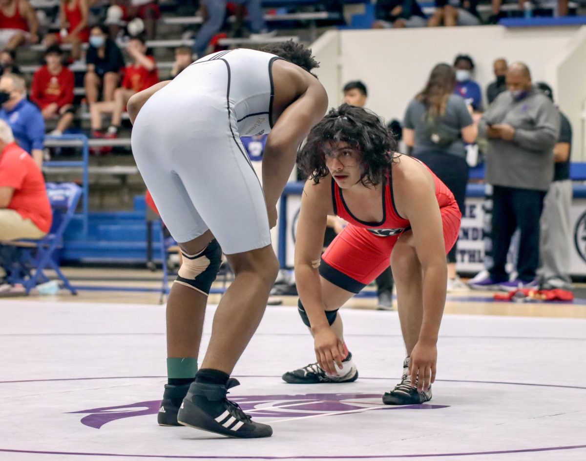 RUNS IN THE FAMILY. Senior Mickio Lopez looks to his opponent, Jacob Whitaker, during the 2021 district tournament April 7. Lopez qualified for the regional tournament and then advanced to state as an alternate. His younger sister Princess Lopez also advanced to state five years later.